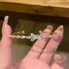 Pulseira aberta de zircônia coreana em formato de laço, pulseira de temperamento de nicho de alta qualidade, pulseira requintada de nova personalidade, atacado
