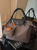 Bolsa de ombro transversal feminina transfronteiriça de grande capacidade, nova moda outono 2026, versátil, bolsa tote para escola e trabalho