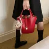 Bolso tipo cubo de estilo coreano súper popular y de nicho, nuevo modelo de verano 2026 para mujer, bolso de hombro y cruzado simple y elegante para el trabajo