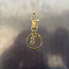 Clipe de Cachorro Giratório Conjunto de Corrente de Quatro Seções Conjunto de Três Peças, Clipe de Cachorro com Fivela em Oito, Mosquetão, Pingente de Contas, Chaveiro com Mosquetão