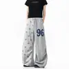 Pantalones de chándal casual retro estilo americano con estampado de estrellas y patchwork, pierna curva, unisex, colección primavera/otoño, corte holgado, pierna ancha, versátiles, pantalones hasta el suelo