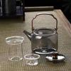 Tetera de vidrio de borosilicato resistente a altas temperaturas, venta al por mayor, estufa de cocina de té rodeada, tetera de cocina doméstica