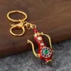 Llavero de frasco de lámpara mágica estilo étnico retro con diamantes, colgante metálico de tetera con goteo de aceite, decoración de bolsa de recuerdo de viaje