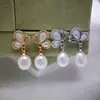 Aretes de perla de agua dulce natural con moño de nácar transfronterizos, broqueles de plata 925, aretes de lujo ligero de alta gama, aretes para mujer al por mayor