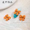Nuevo diseño de uñas con diamantes, perlas y lazo, joyería con textura esmerilada, decoración tridimensional, accesorios para celebrar el Año Nuevo en Internet.
