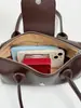 El popular bolso baguette de nicho de lujo de otoño, un diseño de alta gama, moderno y minimalista, perfecto para ir al trabajo y versátil para el uso diario como bolso de mano, bolso de hombro o bolso de axila