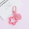 Llavero con hebilla de puerta giratoria, colgante de pentagrama y corazón transparente de colores, accesorio hecho a mano para bolsos