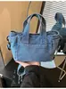 Bolsa de mano de mezclilla para mujer, gran capacidad, nuevo modelo verano 2026, simple y elegante, bolso de un solo hombro para la escuela y el trabajo