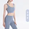 Novo conjunto de fitness e yoga de alta elasticidade e sem costura para mulheres, com design de cintura alta e formato de pêssego para levantar o bumbum, adequado para corrida e treinamento, um conjunto de duas peças