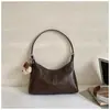Bolso de axila coreano de nicho transfronterizo para mujer, nuevo bolso de moda tipo media luna 2026, bolso de hombro cruzado simple y versátil, moderno