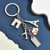 Llavero de metal de moda con múltiples colgantes, tema de vacaciones en la playa, llavero de dibujos animados lindo, estilo versátil
