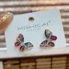 Pendientes de botón de mariposa estilo étnico bohemio diseño de nicho sentido del temperamento pendientes de celebridad de internet pendientes versátiles para el trabajo