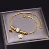 Joyería transfronteriza europea y americana pulsera de hueso de serpiente de cuentas de la suerte de diamantes completos colgante redondo romano en forma de ojo pulsera de acero de titanio con flores