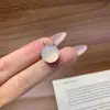 Pingente de calcedônia tipo gelo totalmente cravejado de diamantes para mulheres, apresentando uma vibrante pedra preciosa pequena olho de gato verde e branca, uma corrente delicada e uma corrente para clavícula, oferecendo um toque de luxo discreto.