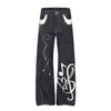 Jeans unisex G60120 estilo americano de calle para streetwear con patchwork de notas musicales y diseño bordado, jeans para hombre ligeramente acampanados color denim original