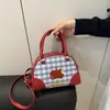 Bolso de mano a cuadros fresco y lindo para mujer, mochila y bolso cruzado nuevos de moda y con estilo estilo universitario para el verano de 2026