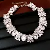 Juego de collar, aretes y colgante de flor ovalada con incrustaciones de diamantes en aguja de plata, joyería de diseño de moda europea y americana de alta gama, lujo ligero