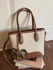 Bolso de mano tipo cubo nuevo de primavera 2026, transfronterizo, estilo vintage simple, de alta gama, moderno, para ir al trabajo, bolso de hombro cruzado de moda