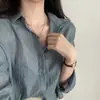 Camisa de verão coreana estilo ins, simples, cor sólida, de abotoamento simples, gola de lapela, plissada, manga longa, corte solto, curta, protetora do sol