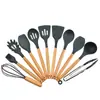 Venta al por mayor de fábrica Amazon Juego de utensilios de cocina de silicona con mango de madera Juego de 11 piezas Utensilios de cocina Olla para cocinar Pala Cuchara