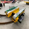 Grande Transportador Elétrico de Plataforma para Manuseio de Grandes Rolos de Papel em Oficinas, com Sistema de Correia de Corrente de Mesa para Integração na Linha de Produção e Carro sobre Trilhos Alimentado por Bateria