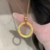 Tienda de oro con alta retención de color método antiguo oro de arena nazha con colgante de anillo Gankun esmalte anillo Gankun hebilla de paz mujer