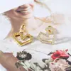 Pendientes únicos de corazón hueco geométrico con detalles de diamantes, exquisitamente incrustados con piedras de circonita, que ofrecen un estilo dulce y cool, y un toque de lujo discreto.