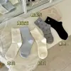 Calcetines con botón de lazo para mujer, calcetines de media pantorrilla para primavera y otoño, calcetines de algodón holgados de color liso versátiles casuales