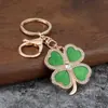 Llavero popular de moda transfronterizo de trébol de cuatro hojas de la suerte, elegante llavero para bolso de mujer, colgante para llavero de coche