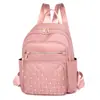 Mochila de moda versátil de tela Oxford con patrón de rombos y remaches, para viajes, capacidad grande, casual, para mujer, 2025