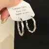 Pendientes de diseño minimalista exquisito estilo europeo y americano con textura retorcida, pendientes de alta gama modernos y lujosos para mujer