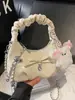 Bolsa Pequena Plissada com Laço Estilo Novo Primavera 2026 Bolsa de Mão Feminina Retrô Bolsa Nuvem Bolsa Transversal com Corrente Bolsa de Trabalho