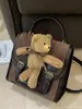 2026 Nueva Bolsa Linda de Dibujos Animados Mochila Retro de Oso para Mujer para la Escuela Mochila Versátil para el Viaje Diario