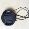 Cámara directa de fábrica universal alta calidad pellizco medio Sin palabras Cubierta de lente Cámara SLR Cubierta de hebilla anti-pérdida venta al por mayor