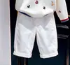 Estilo Coreano Niños 2026 Otoño Nueva Moda Caricatura Letra Bloque de Color Suéter de Punto Pantalones Casuales Blancos Infantiles Modernos