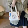 Bolsa Graffiti Exquisita para Mulheres 2025 Novo Estilo Versátil Bolsa de Ombro Grande Capacidade Tendência Bolsa Feminina Bolsa de Mão Transversal