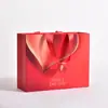 Bolsas de regalo rojas hechas a medida para tiendas de ropa, bolsas de papel de alta gama personalizadas para joyería, bolsas de compras para cosméticos con impresión