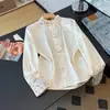 Nueva camisa de mujer estilo chino, nuevo modelo otoño 2026, bordado abotonado retro, cuello mao, camisa blanca con un diseño único