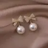 Pendientes de Lazo Rojo con Perlas y Pedrería Incrustada de Venta Caliente Transfronteriza Pendientes con Sentido de Diseño Nicho Pendientes de Lujo Ligero Clavos Europeos y Americanos Venta al por Mayor