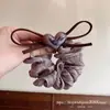 Goma para el pelo de malla con lazo de corazón color marrón claro estilo Dongdaemun coreano, nuevo modelo 2026 con un toque de alta gama para peinados de coleta