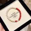 Pulsera elástica de estilo chino con perlas Shijia perfectamente redondas y espaciadores de cinabrio imperial para mujer, Pulsera elástica retro de alta gama única