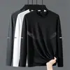 Camiseta elástica de manga larga para hombre, corte holgado, adecuada para primavera y otoño, color liso, versátil, se puede usar como atuendo de pareja, capa interior para hombre