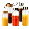 Artículos en Stock de Fábrica Dropshipping Vaso de Agua de Vidrio de Borosilicato Alto Tapa de Madera de Bambú Vaso para Jugo de Frutas Vaso para Bebidas Tapa de Acero Inoxidable Vaso para Café