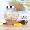 Venta al por mayor de fábrica Botella Transparente de Tambor Plano para el Hogar Sellada a Prueba de Humedad Tarro de Almacenamiento para Cereales y Frutas Secas Tarro de Almacenamiento de Vidrio Embotellado