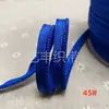 En stock 48 colores poliéster velcro con borde de cordón ribeteado tira de inserción de cuerda para ropa colchas sofás cojines tira de ribete