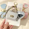 Nueva funda de espejo para auriculares de color sólido en forma de corazón, mini monedero simple, llavero portátil, accesorio de bolso de alta gama