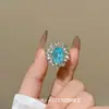 Anel oval deslumbrante azul e prateado estilo palácio com diamantes totais, design de nicho requintado e de luxo leve, anel de luxo de alta qualidade e alta resistência