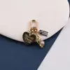 Nuevo hebilla de puerta creativa con corazón hueco de aleación de perla, llavero, funda de auriculares y charm para bolso DIY, joyería