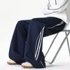 Calça de moletom esportiva listrada color-block estilo retrô americano, coleção de outono masculina, versátil, modelagem solta, calça casual de perna larga, disponível em estilo para casal, calça comprida