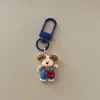 Lindo llavero de overol de cachorro de dibujos animados, colgante creativo personalizado para bolso, decoración de mochila para estudiantes, regalo de accesorio